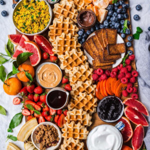 Breakfast charcuterie board with waffles and fruit